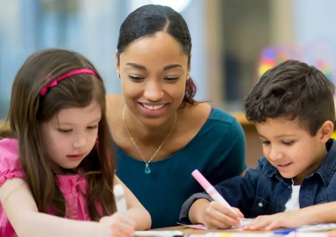 Children concentrating on self-chosen tasks, developing autonomy and focus.