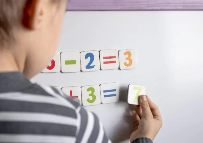 Classroom with Montessori learning materials organized on accessible shelves for student use.