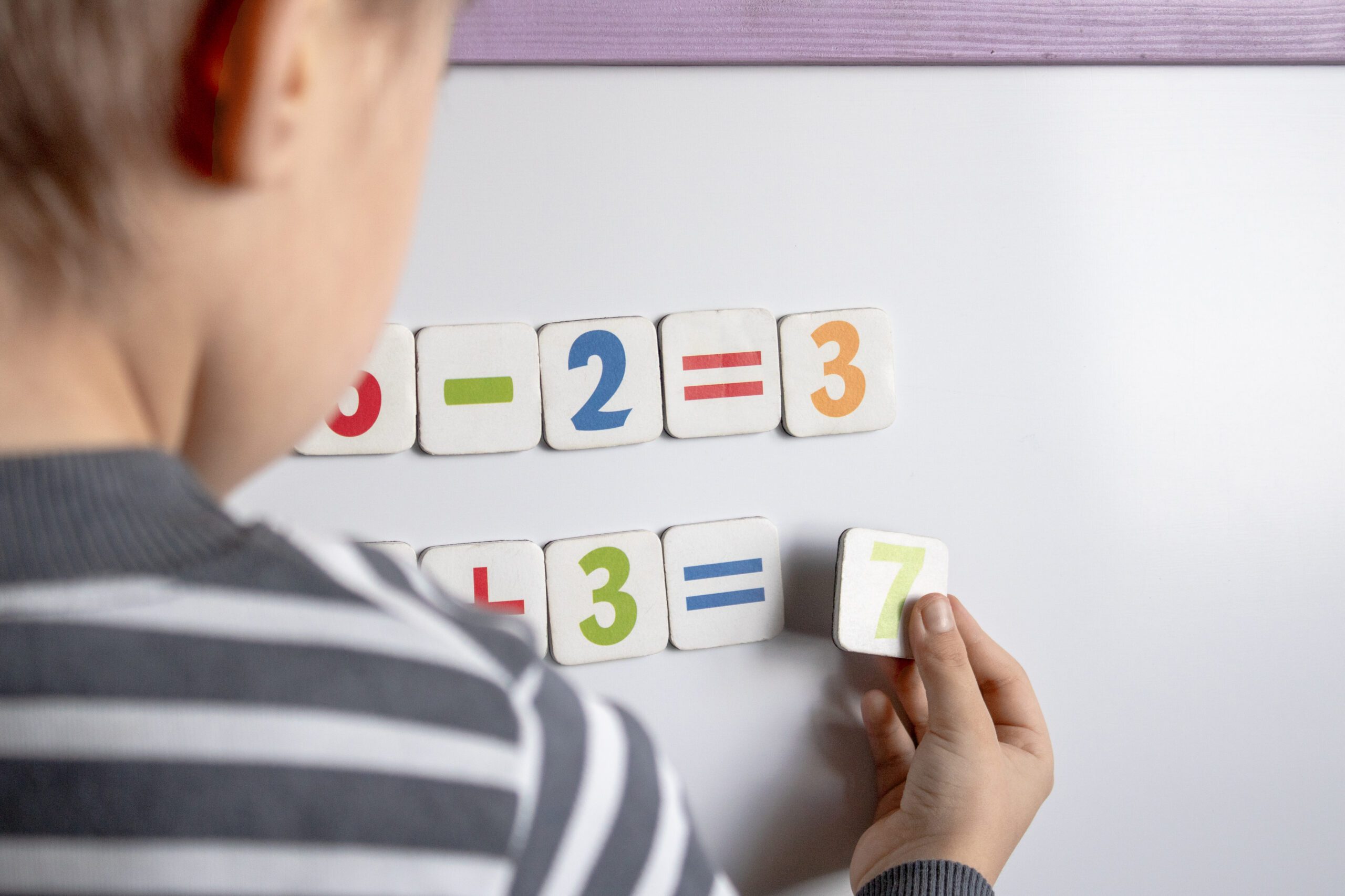 Classroom with Montessori learning materials organized on accessible shelves for student use.